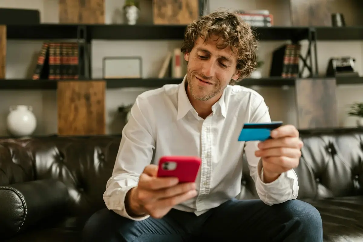 Man with credit card on his phone